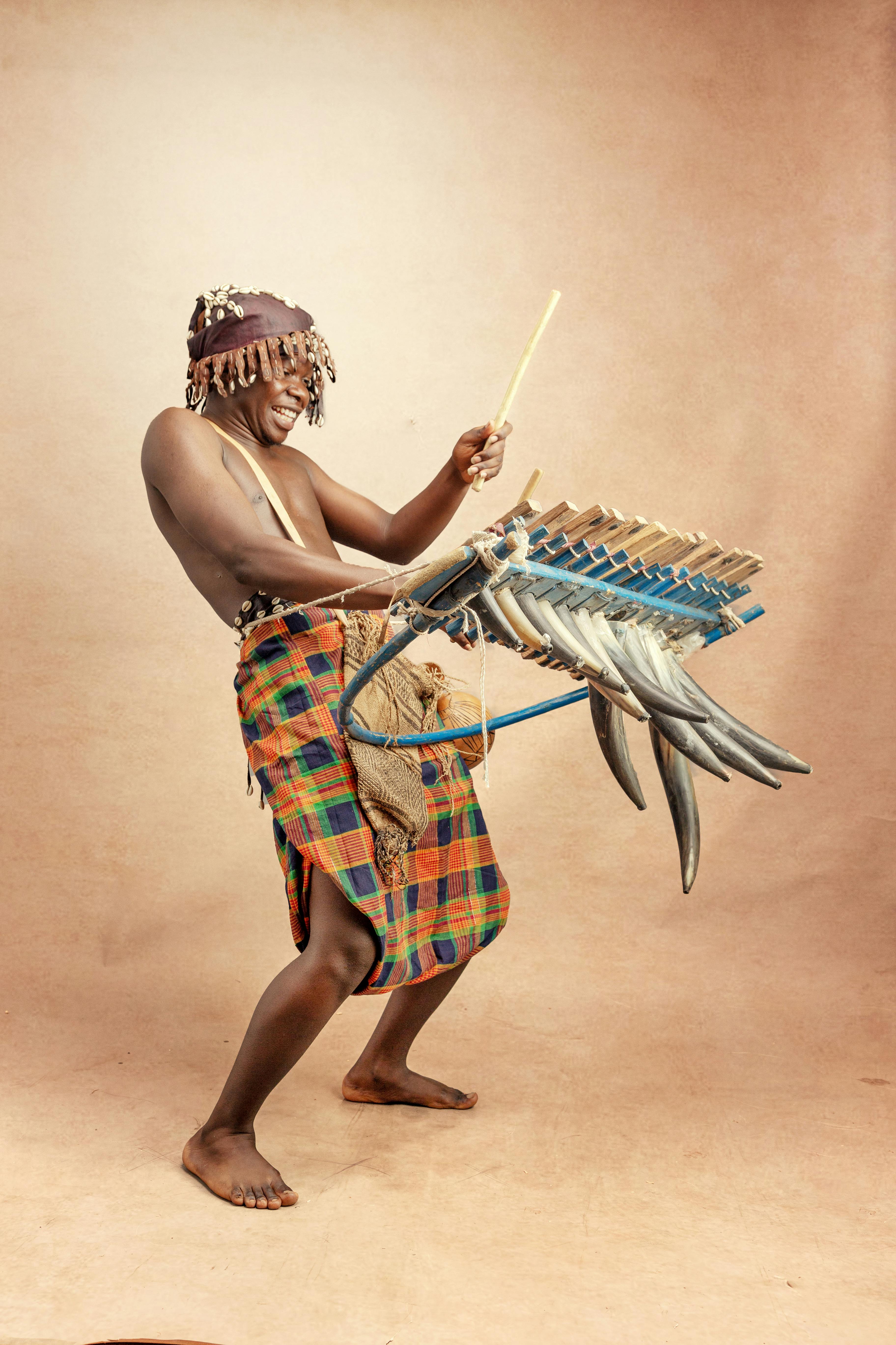 African man playing traditional music instrument